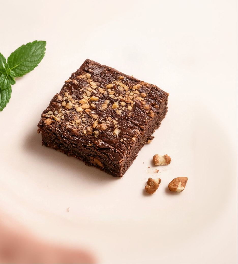 Brownies Basket advertisement with a brownie and mint leaves on a light background